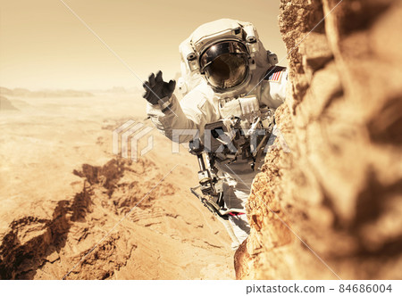 Astronaut Martian is on a mission to the red planet and climbs up a mountain on a rock. Space man conquers and populates the new planet Mars. Planet Mars and people, concept. Welcome to new home Astronaut Martian is on a mission to the red planet and climbs up a mountain on a rock. Space man conquers and populates the new planet Mars. Planet Mars and people, concept. Welcome to new home 84686004