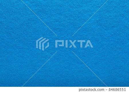 Fine grain blue woolen felt. Texture background. Velvet scarlet matte background of suede fabric 84686551