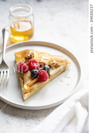 Apple tart or galette with cinnamon and fresh berries. Home baking. 84688237
