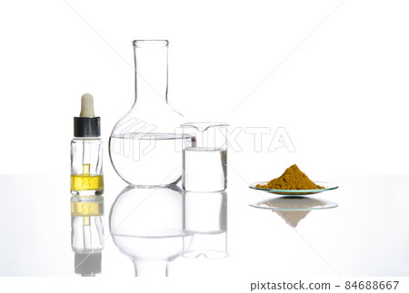 Closeup chemical ingredient on white laboratory table. Yellow cosmetic liquid in Dropper Bottle, Crystal clear liquid in Flat Bottom Flask and Organic Curcuma Powder in Chemical Watch Glass. Closeup chemical ingredient on white laboratory table. Yellow cosmetic liquid in Dropper Bottle, Crystal clear liquid in Flat Bottom Flask and Organic Curcuma Powder in Chemical Watch Glass. 84688667