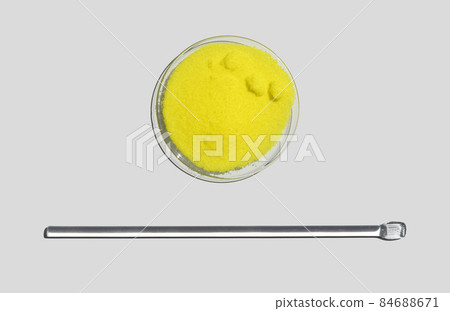 Potassium Chromate Powder in Chemical Watch Glass place next to stirring rod. Closeup chemical ingredient on white laboratory table. Top View 84688671