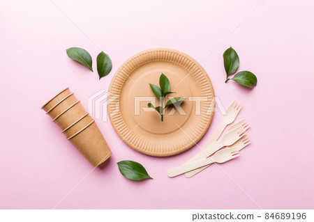 set of empty reusable disposable eco-friendly plates, cups, utensils on light white colored table background. top view. Biodegradable craft dishes. Recycling concept. Close-up 84689196