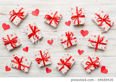 Valentine day composition Background: red gift box with bow and heart. Christmas present. View from above. Holday greeting card 84689426