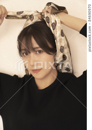 A woman wearing a scarf around her head 84690970