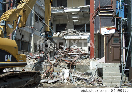 Demolition of steel-framed building with hydraulic excavator Demolition of steel-framed building with hydraulic excavator 84690972