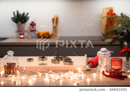 Christmas festively decorated kitchen with christmas lights, and cookie cutters 84691093