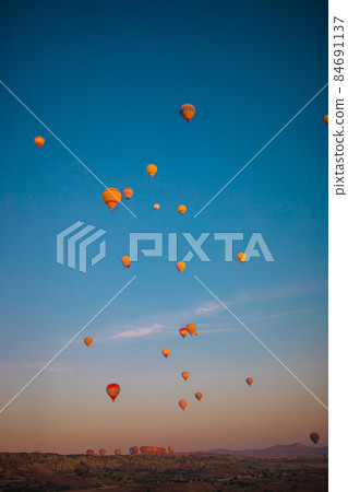 Bright hot air balloons in sky of Cappadocia, Turkey Bright hot air balloons in sky of Cappadocia, Turkey 84691137