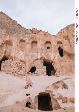 Young woman on the edge of canyon in Cappodocia 84692328