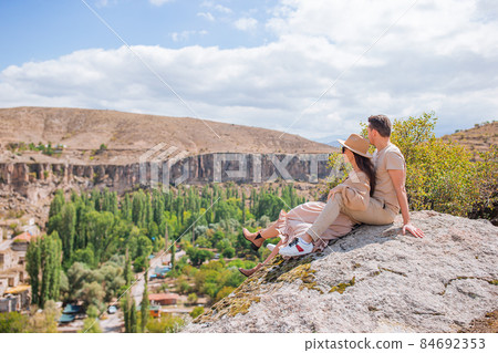 Happy couple on summer vacation in famous place. Cave formations. 84692353