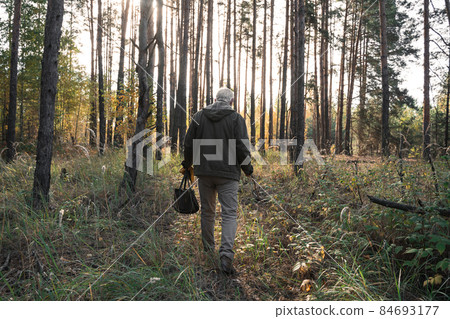 Man looking at the nature while being at the forest alone and relaxing 84693177