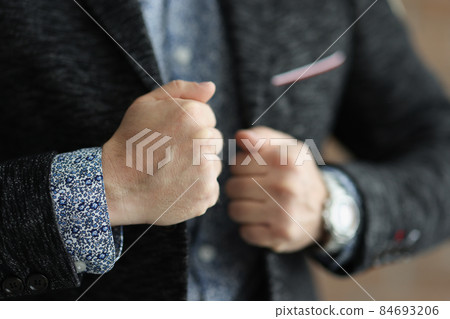 Business man touching his stylish jacket and feel confident in himself 84693206
