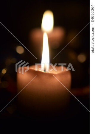 Burning beige candles as a close up 84693364