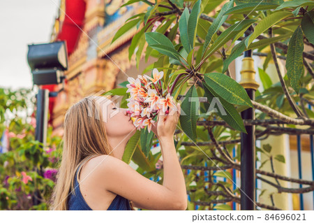 Young woman tourist in Thai temple in Phuket Town Wat Mongkolnimit Young woman tourist in Thai temple in Phuket Town Wat Mongkolnimit 84696021