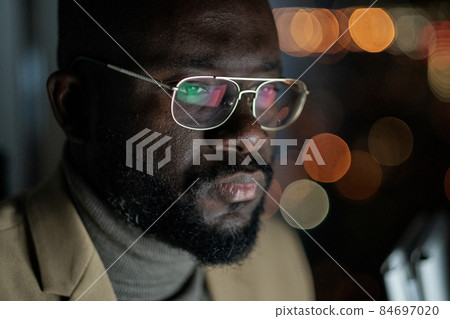 Young African businessman concentrating on network 84697020
