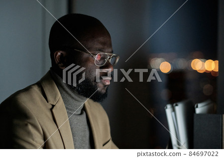 Young elegant businessman in formalwear and eyeglasses working in front of computer 84697022