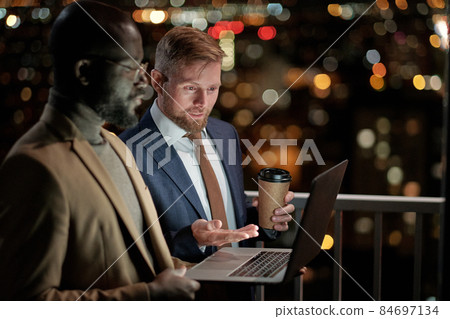 One of two business partners explaining point of presentation 84697134