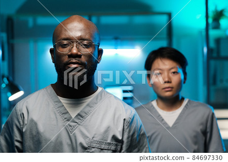 Two young intercultural laboratory workers looking at camera 84697330