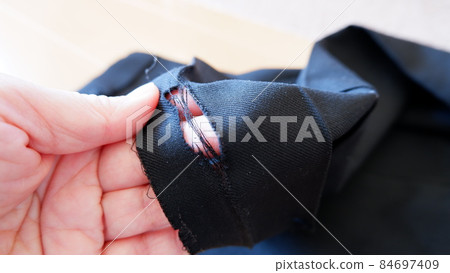 Hole in the hem of school uniform pants 84697409