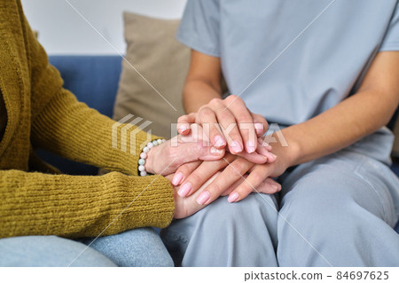 Nurse supporting elderly woman Nurse supporting elderly woman 84697625
