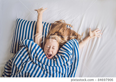 Beautiful young woman lying down in bed and sleeping. Do not get enough sleep concept Beautiful young woman lying down in bed and sleeping. Do not get enough sleep concept 84697906