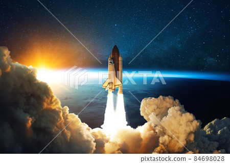 Rocket lift off. Space shuttle with smoke and blast takes off into space on a background of blue planet earth with amazing sunset. Successful start of a space mission. Travel to Mars 84698028