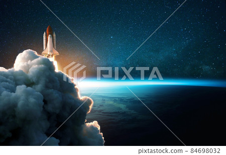 Space rocket lift off into cosmos with smoke and blast on a background of the blue planet earth. Spacecraft flies in space with a starry sky near the planet. Successful start of the mission Space rocket lift off into cosmos with smoke and blast on a background of the blue planet earth. Spacecraft flies in space with a starry sky near the planet. Successful start of the mission 84698032