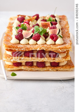 Milfey. dessert of puff pastry, vanilla cream and raspberries 84698346