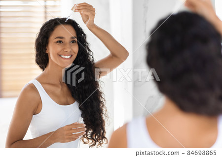 Skincare Concept. Beautiful Young Woman Applying Face Serum With Dropper In Bathroom Skincare Concept. Beautiful Young Woman Applying Face Serum With Dropper In Bathroom 84698865