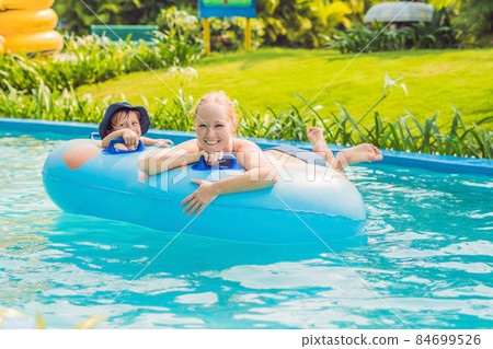 Mom and son have fun at the water park 84699526