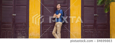 BANNER, LONG FORMAT Man tourist on background of Hoi An ancient town, Vietnam. Vietnam opens to tourists again after quarantine Coronovirus COVID 19 84699863