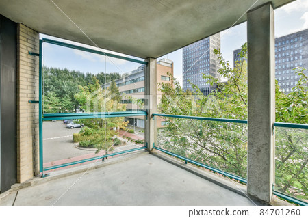 Large concrete balcony with glass railings and amazing view Large concrete balcony with glass railings and amazing view 84701260