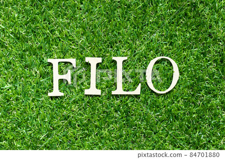 Alphabet letter in word FILO (abbreviation of first in last out) on green grass background Alphabet letter in word FILO (abbreviation of first in last out) on green grass background 84701880