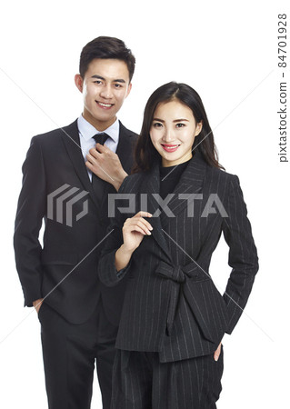 studio portrait of young asian businessman businesswoman looking at camera smiling isolated on white studio portrait of young asian businessman businesswoman looking at camera smiling isolated on white 84701928