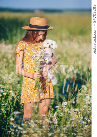 Happy child in field. Beautiful girl in dress in a straw hat Happy child in field. Beautiful girl in dress in a straw hat 84702298