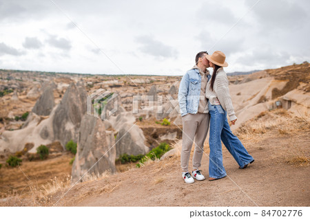 Happy couple on summer vacation in famous place. Cave formations. 84702776