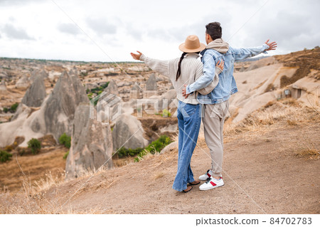 Happy couple on summer vacation in famous place. Cave formations. 84702783
