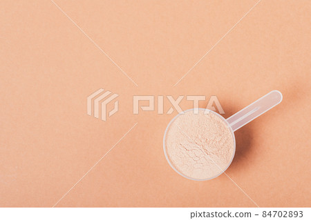Chocolate protein powder in measuring spoon Chocolate protein powder in measuring spoon 84702893