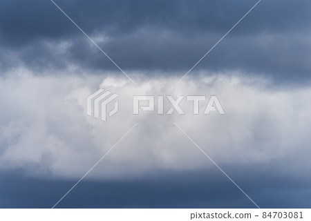 Gray overcast cloudy sky over horizon. Closeup clouds Gray overcast cloudy sky over horizon. Closeup clouds 84703081