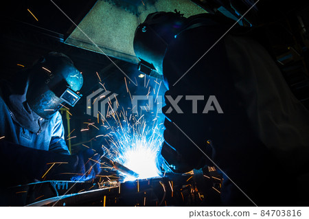 worker with protective mask welding metal 84703816