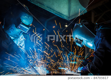 worker with protective mask welding metal 84703817