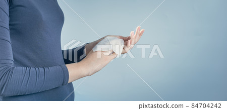 Girl cleaning her hands by using white antibacterial napkin on gray background. Photo with copy space. Girl cleaning her hands by using white antibacterial napkin on gray background. Photo with copy space. 84704242