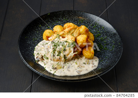 Fried zander fillet with mushroom sauce and potato balls Fried zander fillet with mushroom sauce and potato balls 84704285