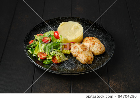 Meat cutlet with mashed potato and fresh vegetables Meat cutlet with mashed potato and fresh vegetables 84704286
