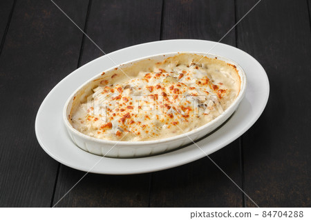 Potato and hamboletus baked in oven with cheese and bacon Potato and hamboletus baked in oven with cheese and bacon 84704288