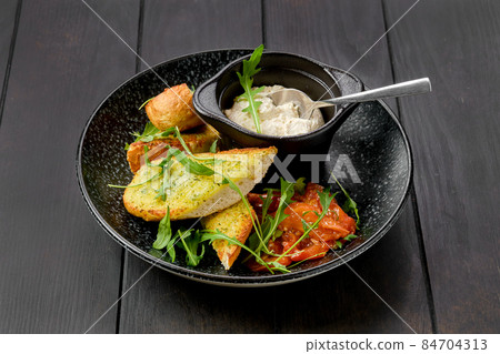 Toasted garlic bread with sour curd and braised tomato 84704313
