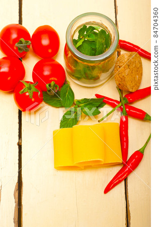 Italian pasta paccheri with tomato mint and chili pepper 84704360