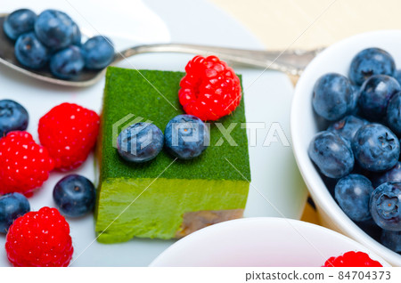 green tea matcha mousse cake with berries 84704373