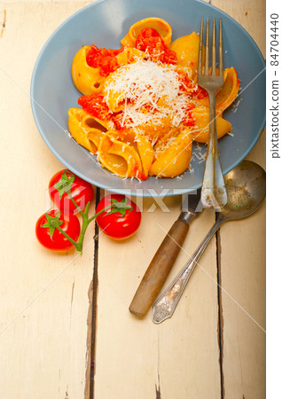 Italian snail lumaconi pasta with tomatoes Italian snail lumaconi pasta with tomatoes 84704440