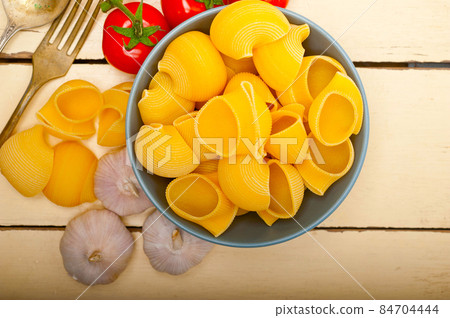 Italian snail lumaconi pasta with tomatoes Italian snail lumaconi pasta with tomatoes 84704444