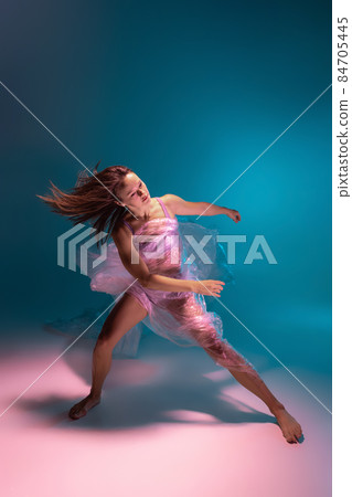 Solo performance. Beautiful flexible contemp dancer dancing with fabric isolated on gradient blue white background in neon light 84705445